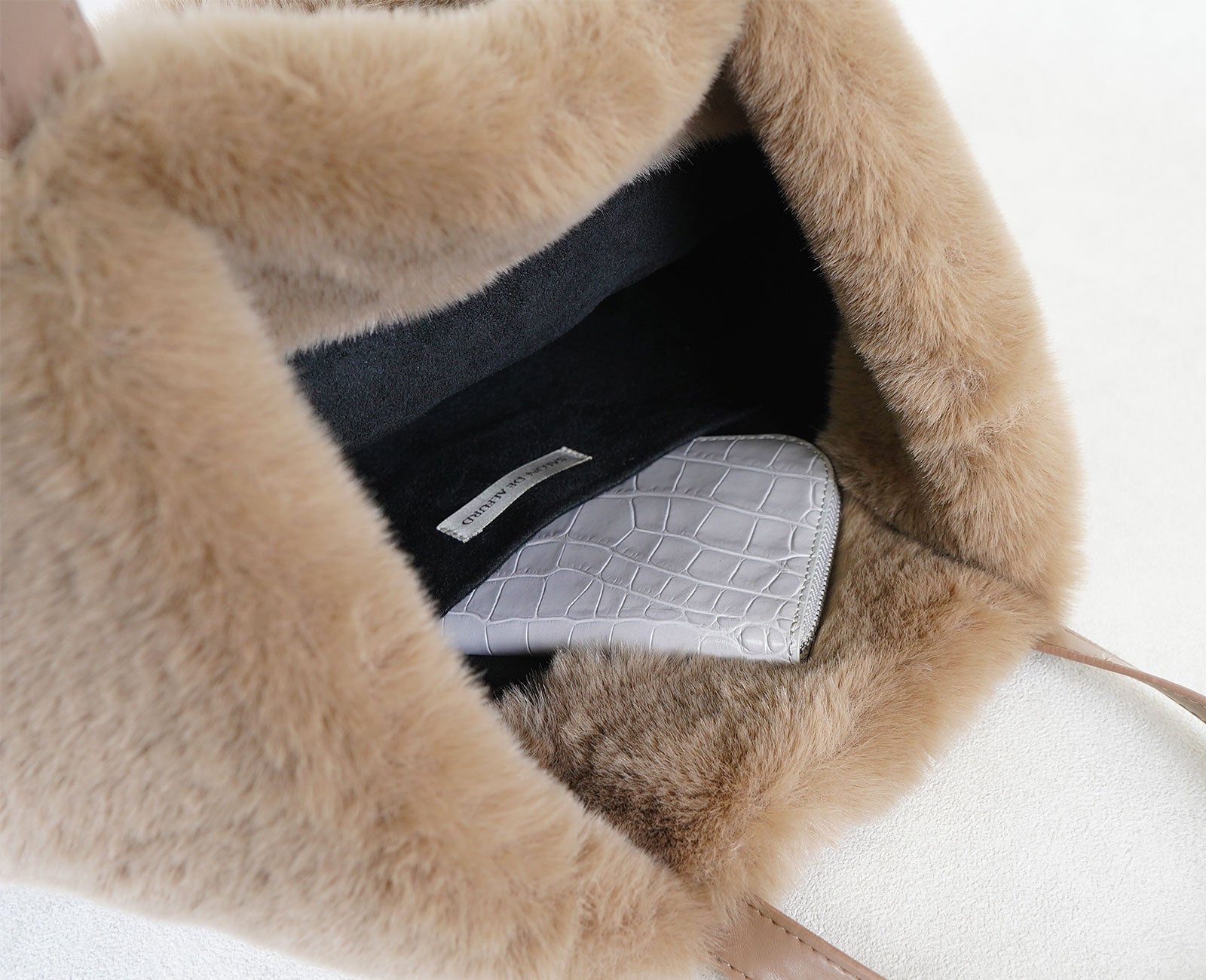 内側にはミニ財布がすっきり収まるサイズのオープンポケットを備え、大切な小物を美しく整理できます