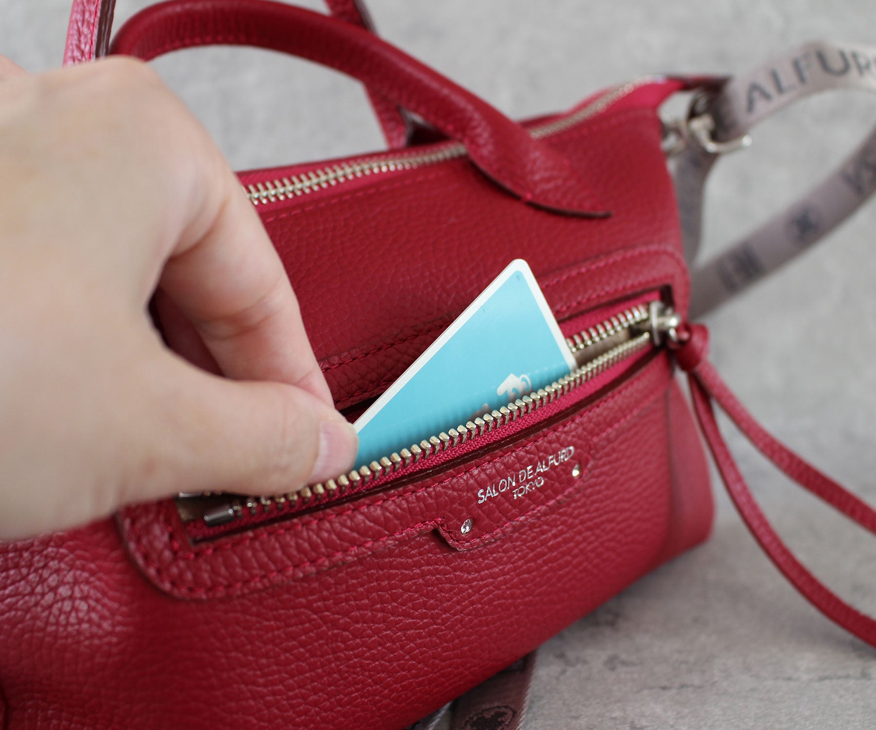 デザインのアクセントになる表面のファスナーポケットは、カードや小物を入れるのにも最適。