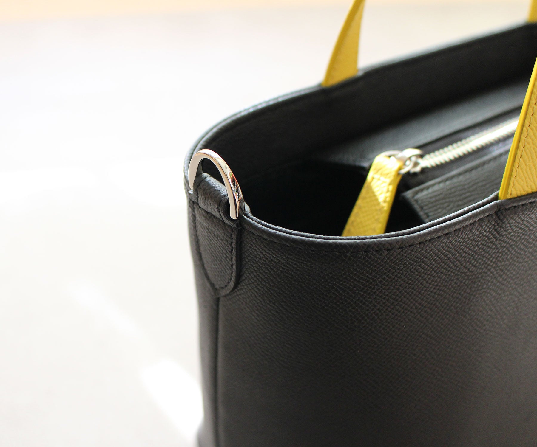 バッグの間口両脇にDカンを装備。お手持ちのロングショルダーを付けて、斜め掛けにも対応します。